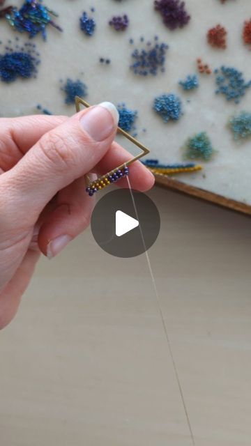 Mile High Beads ~ Kari on Instagram: "A quick look at how I attach the beads to the frame for my Art Deco Fringe Earrings. 🪡   Not only was I lucky enough to get to send out a pair of Art Deco Fringes yesterday, but I have another pair on my Orders-To-Make List, too! 🤗 Thank you so much for keeping me busy! 💓 . . . . . . . . . . . . . #seedbeads #seedbeadjewelry #beadweaving #jewelrymakers #seedbeadearrings #fringeearrings #milehighbeads #makingjewelry #jewelrymakingprocess #processvideo" How To Make Beaded Fringe Earrings, How To Make Fringe Bead Earings, How To Make Fringe Earrings, Diy Beaded Hoop Earrings Tutorials, Fringe Beaded Earrings Tutorial, Fringe Earrings Diy Tutorials, Bead Fringe Earrings Tutorial, Seed Bead Fringe Earrings Tutorial, Diy Seed Bead Earrings Tutorials