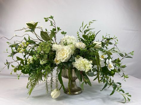 This is a natural white centerpiece filled with real touch roses, a large ranunculus bloom, orchid, and tulips. A large white hydrangea and hydrangea cones can be found mixed between the beautiful real touch blooms. A mix of lush different greenery and twigs have been uniquely designed around the blooms. The centerpiece has been designed on all sides and can be used all year around.  Length: 33 Inches, Width: 20 Inches, Height: 23 Inches (measurements are tip to tip) Thank you for viewing S&B Blumen Design shop. Please contact us with any questions. Hydrangea Arrangements Wedding, Ranunculus Centerpiece, Monochromatic Flowers, Green Centerpieces, White Flower Arrangements, Hydrangea Centerpiece, Large Flower Arrangements, Hydrangea Arrangements, White Centerpiece