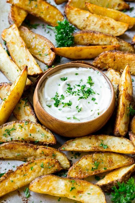 A sheet pan of baked potato wedges with a container of ranch dip. Potato Wedges Fried, Slow Cooker Chicken Marsala, Baked Potato Wedges, Crispy Potato Wedges, Oven Baked Fries, Crispy Baked Potatoes, Potato Wedges Recipe, Potato Wedges Baked, Cooking Whole Chicken