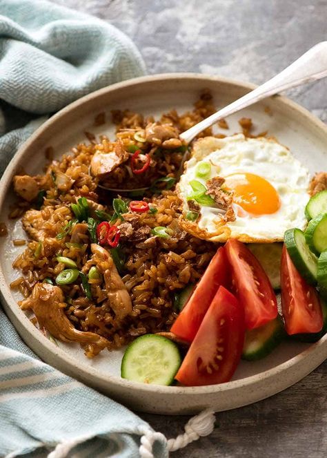 Nasi Goreng on a plate with a side of fried egg, tomato and cucumbers Indonesian Fried Eggs Indonesian Fried Rice Recipe, Nasi Goreng Recipe, Kecap Manis, Recipetin Eats, Recipe Tin, Cooking White Rice, Nasi Goreng, Fried Rice Recipe, Asian Cooking