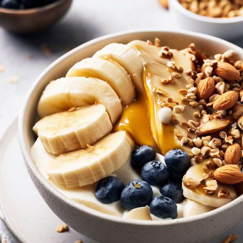 Start your day off right with this sweet and savory breakfast bowl! Greek yogurt provides a creamy and protein-rich base, while sliced banana and blueberries add natural sweetness and a boost of vitamins and antioxidants. A drizzle of almond butter adds healthy fats and a delicious nutty flavor, while a sprinkle of granola provides crunch and a touch of sweetness. #breakfastbowl #healthybreakfast #greekyogurt #fruits #almondbutter Greek Yogurt And Fruit, Greek Yogurt Breakfast Bowl, Sweet And Savory Breakfast, Yogurt And Fruit, Sliced Banana, Yogurt Bowl, Breakfast Bowl, Savory Breakfast, Delicious Breakfast