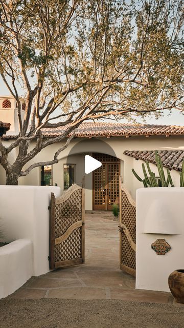 Modern Nest on Instagram: "Welcome to the #mnSantaFeHacienda exterior! This breathtaking design beautifully embodies the spirit of Santa Fe, featuring vibrant Saltillo tile, reclaimed Chicago brick surrounding the pool, hand-selected antique gates, and a custom Spanish cedar door. Each detail invites you to embrace the charm of Santa Fe living, seamlessly blending comfort and style.

Interior design & Build: @modern_nest
Furnishing: @marketbymodernnest
Photography: @modern_nest & @danryan.studio

#ModernNest #ModernNestHomes
——
Interested in owning this special Modern Nest home? See the link in our bio or contact Nick Carlson (480) 200-9471 or Ken Binder (480) 977-0606 @carlsoncollective.

#MarketbyModernNest #SouthwestHomes #southwestdecor #southwestdesign #santafehomes #santafe #santafed Sante Fe Style Homes, Spanish Style Front Porch, Spanish Style Driveway, Santa Fe Style Homes Interiors, Southwest Home Exterior, Southwestern Home Exterior, Spanish Homes Exterior, Modern Adobe House Exterior, Adobe House Exterior