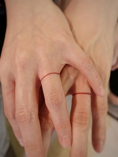 Promise Ring Tattoo Couple, Matching Wedding Tattoo Ideas, Red String Finger Tattoo, Man Ring Tattoo, Ring Tattoo Couple, Red String Tattoo Couple, Red String Ring, Couple Ring Tattoos Marriage, Red Knot Tattoo