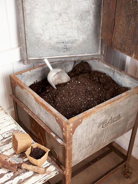 An old washtub, complete with a lid, is a perfect potting soil storage bin. Its large size accommodates several bags of potting soil. When you're not using the soil, put the lid on the tub and use it as work space. Garden Shed Interiors, Potting Benches, Small Backyards, Potting Tables, Greenhouse Shed, Potting Table, Garden Benches, Gardening Landscaping, Backyard Greenhouse