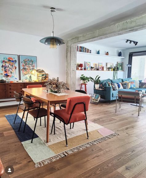 Open Floor Plan With Different Color Walls, Dining Table In Front Of Sliding Door, Dining Room Hang Out Area, Multiple Tables In Dining Room, Living Dining Area Design, Funky Retro Dining Room, Colorful Dining Room Rug, Pendant Above Dining Table, Light Wood Floor Decor