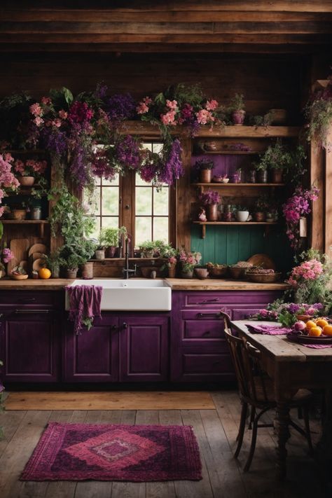 Discover a slice of paradise in this majestic floral-infused rustic kitchen. Dark wooden beams and log walls evoke a cabin feel, while resplendent purple cabinetry and a farmhouse sink add modern flair. Cascades of verdant greenery and vibrant flowers drape from above, creating an ethereal atmosphere. A weathered wooden table, adorned with fresh fruits and blooms, awaits warm gatherings. The charming open shelves exhibit earthenware amidst the foliage. Witchy Studio, Witchy Farmhouse, Studio Seni, Library Kitchen, Witchy Apothecary, Apothecary Kitchen, Witchy House, Whimsical Kitchen, Witchy Home