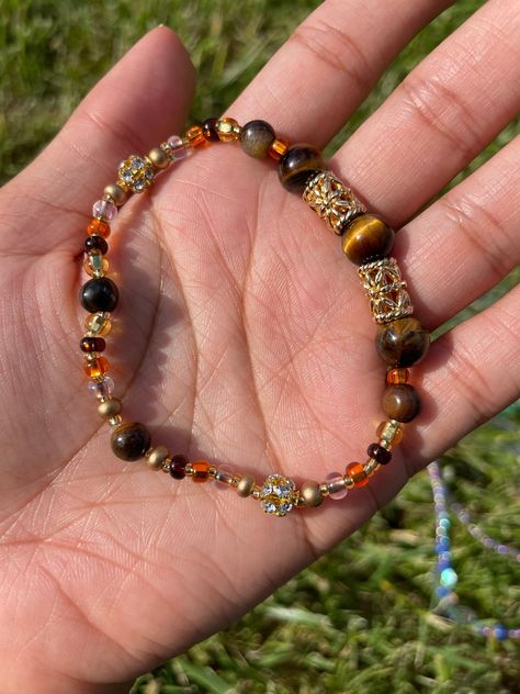 Stretch Bracelet made with Tiger's Eye Gemstones, glass beads, and nickel-free charms Eye Color Bracelet, Big Bead Bracelets, Cool Beaded Bracelets, Bracelet Inspired, Indie Jewelry, Bracelets Design, Dope Jewelry, Tiger Eye Beads, Funky Jewelry