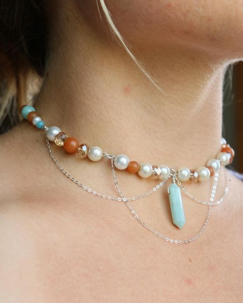 orange & Amazonite crystal silver choker This orange and blue choker feature Amazonite crystals and a central teardrop, with orange crystals (I believe are maybe orange aventurine) and many other accenting beads. I have a friend whose favorite colors are this combo and I was thinking of them while making this piece!🫶🏼 This beauty can be found on my website using the link on my page! • • • • • • #crystaljewelry #wirewrapping #wirewrap #wirejewelry #wirewrappedjewelry #silverjewelry #silverw... Orange Choker, Orange Aventurine, Amazonite Crystal, Blue Choker, Orange Crystals, Silver Choker, Beaded Necklaces, Wire Wrapped Jewelry, Wire Jewelry