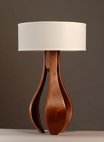 Chloe in Walnut with White Shade by Kyle Dallman. An elegant, harmonious design handcrafted from walnut wood. Three gently curving legs, created using the bent lamination technique, are given a hand-rubbed oil and varnish finish that accentuates the warmth and beauty of the wood grain. Topped with a simple white shade. Dimming fixture uses one 100-watt max. bulb (not included). Interesting Lamps, Wooden Work, Tree Bookshelf, Wood Table Lamp, Table Lamp Wood, Decorative Lighting, Wooden Lamp, Room Lighting, Wood Lamps