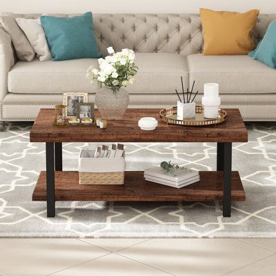 Center your living room or den around coastal farmhouse charm with this coffee table. We love the mixed material look that is so on trend, as well as the marriage of textures and finishes that this piece brings to the table. It is crafted from high-quality MDF board with visible grain variation in a rustic brown finish. With two large spacious tiers, you’ll have enough room to store or display your favorite centerpiece or entertainment essentials. The lower shelf gives you a spot to set down a s