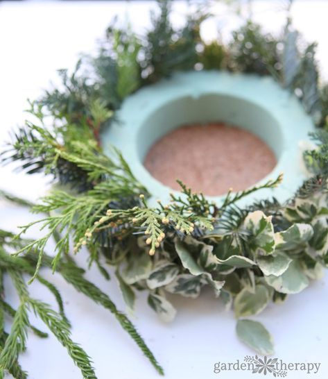 Make this simple DIY Christmas candle wreath for a stunning holiday centerpiece Candle Arrangements Christmas, Christmas Table Wreath Centerpiece, Candle Ring Centerpiece, Diy Candle Wreath Rings, Christmas Wreath Table Centerpiece, Christmas Candle Rings Diy, Christmas Candle Wreath, Diy Candle Ring, Wreath Centerpiece Christmas