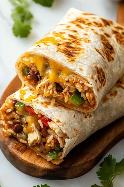 These easy slow cooker chicken burritos make dinner a breeze! With beans, rice, peppers, onions, and salsa, they're guaranteed to satisfy. Crock Pot Burrito Chicken, Healthy Burritos Recipe, Healthy Mexican Burritos, What To Do With Burrito Tortillas, Cheesy Chicken And Rice Burritos, Meals With Salsa Dinners, Bean And Rice Burrito Recipe, Crock Pot Chicken Burritos, Mission Burrito Recipe