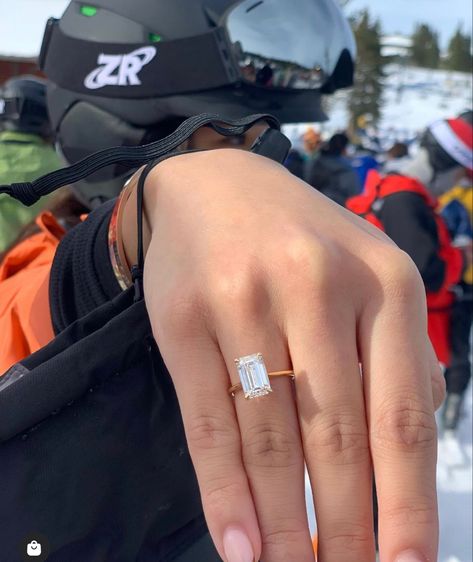 Photo of a 3.5 carat emerald cut natural diamond set in a yellow gold thin band solitaire.  Shown on hand of a snowboarder white black helmet and goggles. Northstar ski resort in background. Tag Your Love, Dream Wedding Ring, Get Engaged, Timeless Engagement Ring, Ring Cuts, Emerald Cut Diamond Engagement, Emerald Cut Diamond Ring, Cute Engagement Rings, Future Engagement Rings