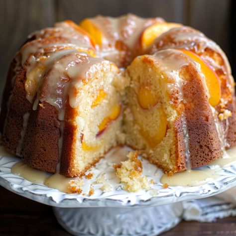 Easy Sour Cream Peach Pound Cake is a celebration of the season's finest flavors, combining the richness of traditional pound cake with the lusciousness of fresh peaches. Whether enjoyed as a dessert or a sweet indulgence with your morning coffee, this cake is sure to Apricot Nectar Pound Cake, Fresh Peach Bundt Cake, Sour Cream Peach Cake, Cakes With Fruit In Them, Summer Bunt Cakes, Sour Cream Peach Pound Cake, Peach Pound Cake Recipe Sour Cream, Peach Bundt Cake Easy, Fresh Peach Bundt Cake Recipes