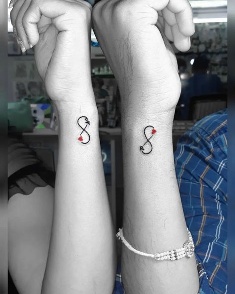 Matching infinity tattoo designs for couples who want to claim their love for each other. Cute, minimalistic couple tattoo ideas. Cute Boyfriend Tattoo Ideas, Couples Mini Tattoos, Gaming Couple Tattoos, Stronger Together Tattoo, Cute Matching Couple Tattoos, Infinity Matching Tattoos, Wifes Name Tattoo Ideas For Men, Tiny Couples Tattoos, Marriage Tattoos Husband Wife