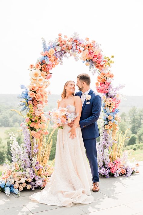 Bride and groom at pastel rainbow wedding arch #rainbowwedding #pastelwedding #floralwedding #rainbowflorals Wedding Ideas Summer Colors, Pastel Wedding Theme, Bridgerton Wedding, Colorful Summer Wedding, Wildflower Wedding Theme, Lover Album, Rainbow Wedding, Bright Wedding, Summer Wedding Colors