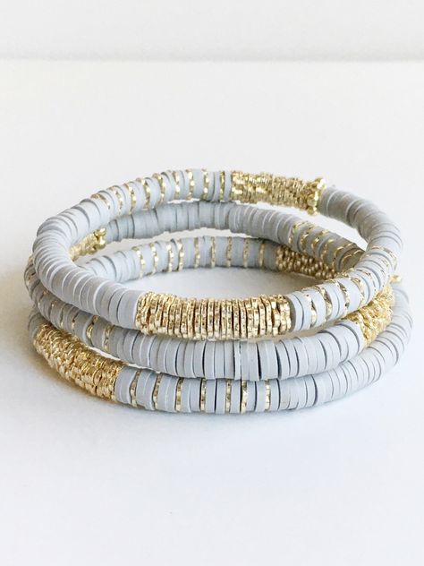 Light Gray Confetti and Gold Beaded Bracelet ⟡ all items are designed and handcrafted in our studio ⟡ Hand strung vinyl and 14kt gold plated beads on stretch material. Fun, lightweight, colorful bracelets - perfect for year round. A combination of polymer clay vinyl beads and 14kt gold plated beads. Each bracelet is stretchable and easily layers with other bracelets or a watch. The bracelet cannot be opened, and need to fit over your hand. Treat yourself to a fun new bracelet! These bracelets ar Polymer Clay Beaded Bracelet, Clay Beads Jewelry Making Tools, Clay Bead Patterns Bracelet, Gray Clay Bead Bracelet, Clay Bead Bracelet Ideas Neutral Colors, Polymer Clay Bead Jewelry, Hieshi Clay Bracelets, Trendy Bracelets 2023, Round Bead Bracelet Ideas