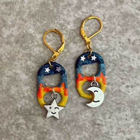 Love you to the moon and back! Enjoy your starry nights with these hand painted earrings featuring cute star and moon charms and lever back closures. You can see the optional matching bracelet here: https://www.etsy.com/listing/550839941/sun-and-moon-soda-pop-tab-bracelet-blue?ref=shop_home_active_22&sca=1 I use lever back closures on all my earrings because they close easily and are harder to accidentally lose. All items are handmade by me in my smoke free, pet friendly home, and available to s Tab Earrings, Soda Tab Crafts, Pop Tab Crafts, Pop Tabs, Celestial Blue, Yellow Glitter, Funky Earrings, Diy Crafts To Do, Moon And Star