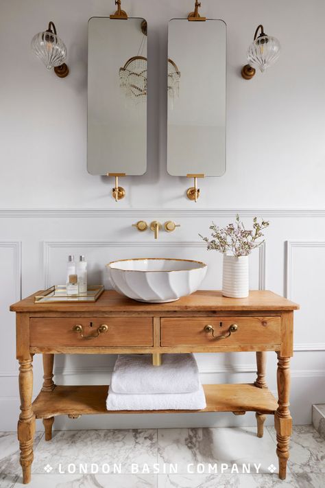 Having taken her cue from a French sideboard she found in an antiques shop, interiors blogger Phoebe Miller sought the perfect basin to sit on top. The delicate design of the Angelica basin tied in beautifully with the bath and light fittings to transform the bathroom into a tranquil oasis. Read our blog for design inspiration. Italian Toilet Design, Bathroom Basins Ideas, Turn Of The Century Bathroom, Sink Ideas Bathroom, French Bathroom Decor Vintage, Parisian Style Bathroom, Italian Bathrooms, Powder Room Vanity Ideas, Bathroom Island