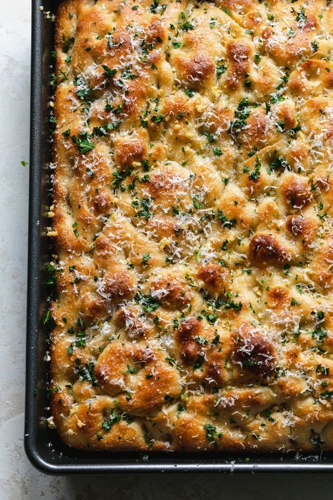 This Garlic Bread Focaccia is fluffy on the inside, crunchy and deeply golden on the edges, and doused in melted garlic butter. It's undoubtedly on of the best things to ever come out of my kitchen. It's the perfect vehicle for sandwiches, served with soup, dipped in more garlic butter (!!), or just simply eaten on its own. Salty, garlicky, buttery, fluffy, crunchy, golden brown perfection! Foccacia Bread Half Baked Harvest, Focaccia Bread Sticks, Best Bread For Chili, Garlic Herb Focaccia Bread, Focaccia And Dip, Breads To Go With Soup, Cheesy Garlic Sourdough Foccacia Bread, Foccacia Bread Garlic Butter, Foccacia Bread Sheet Pan