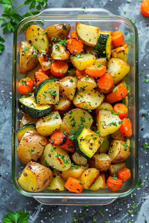 Craving a side dish that’s both delicious and healthy? This recipe for Garlic Herb Roasted Potatoes, Carrots, and Zucchini is a dish so flavorful that it’s sure to convert even the pickiest eaters into veggie lovers.Gluten-free, dairy-free, vegan, and Whole30 compatible, it’s a healthy and delicious choice for everyone. Side Dishes For Potatoes, Ways To Prepare Vegetables, Roasted Potatoes Carrots Zucchini, Roasted Potatoes Zucchini And Squash, Garlic Herb Roasted Potatoes And Carrots, What To Eat With Fish Side Dishes, Roasted Potatoes And Zucchini In Oven, Potato And Veggies Recipes, Heart Healthy Potato Recipes