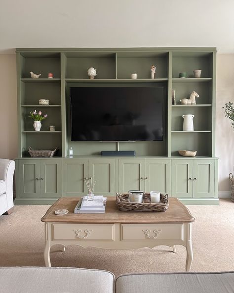 Happy Sunday! This is my current view as I sit with a cup of tea, a good book and a very sleepy puppy ☺️☕️ I get lots of questions about the media unit in the living room - we had the unit built bespoke by a local carpenter and then painted it in F&B Treron (colour matched with Brewer’s paint) 💚 The cupboard handles are from @ah_brass and our tv size is 65’ I’m so glad I went with the bold colour! It’s the focal point of the room and I love it 🥰 . . #mediaunit #mediawall #mediawalldesi... Fitted Cabinets Living Room, Media Units Living Room, Built In Tv Cabinets Living Room, Built In Living Room Cabinets, Living Room Built Ins With Tv, Lounge Cupboards, Media Unit Living Room, Built In Cupboards Living Room, Living Room Built In Cabinets