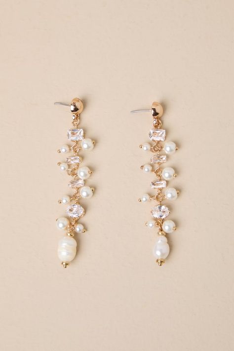 If you have an instinct for elegance, you need the Lulus Decadent Approach Gold Pearl Rhinestone Drop Earrings! Shiny, gold-toned metal shapes these stunning earrings that have a drop silhouette with various sizes and cuts of rhinestones (along with luminous faux pearls) strung across their length. Post backs. 3" Long. 40% Iron, 40% Plastic, 20% Pearl. Imported. Lulus | Decadent Approach Gold Pearl Rhinestone Drop Earrings. Opal Wedding Earrings, Hoco Earrings, Hoco Jewelry, Pearl Dangle Earrings Wedding, Wedding Earrings Bride, Pearl Wedding Accessories, Hoco Inspo, Pearl Bridesmaid Jewelry, Gold Pearl Jewelry