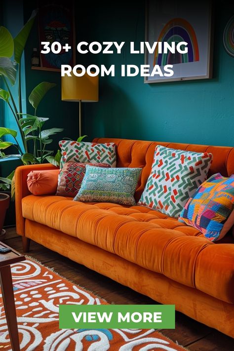 This eclectic living room showcases a bright orange sofa with colorful patterned pillows, set against teal walls. Unique artwork and a mix of textures create a vibrant and cozy space. Contrast Sofas Living Room, Orange Sofas Living Room, Living Room Sofa Not Against Wall, Orange Sofas Living Room Ideas, Mix Sofas Living Rooms, Colorful Sofas Ideas Living Room, Bright Sofa Living Room, Teal Sofa Living Room Ideas, Comfy Tv Room