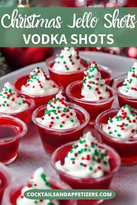 Pretty Christmas Jello shots for your holiday party! Easy to make jello shots made with vodka and cherry jello, topped with whipped cream and holiday sprinkles. Christmas Jell O Shots Holiday Parties, Christmas Party Jello Shots Tree, Christmas Alcoholic Jello Shots, Jello Shot Christmas, Mistletoe Jello Shots, Santa Hat Jell-o Shots, Nye Jello Shots Vodka, Hello Shots Christmas, Christmas Jello Shots Vodka