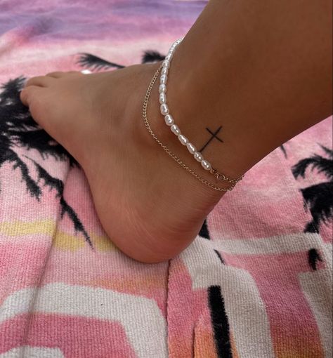 Tattoo | tattoo ideas by  Norman Aguilera Cute Tattoos Ankle, Women Tattoos Underboob, Tiny Women Tattoos, Ankle Tattoo Aesthetic, White Ink Cross Tattoo, Cross Foot Tattoo, Cross Tattoos For Women Ankle, Cute Small Ankle Tattoos, Tiny Cross Tattoos For Women