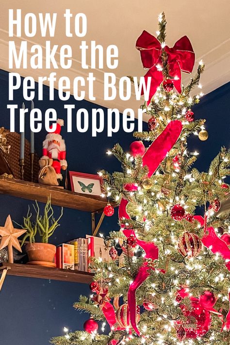 Beautifully decorated Christmas tree in red ornaments and ribbon with a beautiful bow tree topper against a blue wall Diy Bow Topper Christmas Trees, Christmas Bow Tree Toppers Diy, Christmas Tree Topper Bow Tutorial, Christmas Tree Topper Tutorial, Christmas Tree Topper Bow Diy, Christmas Tree Topper Ribbon, Christmas Tree Toppers Unique, Bow Tree Topper, Diy Tree Topper