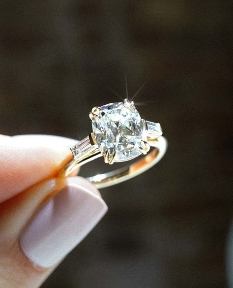 3CT Antique Inspired Elongated Cushion Cut Moissanite Diamond Engagement Ring | 10/14/18K Gold Side Baguette Cut Wedding Ring For Her ✥ Custom Order: * If you cannot find the piece your heart truly desires in my shop, I promise and guarantee that I can make it for you. Just send me a picture or an illustration, and I can start a conversation about your dream piece ✥ Stone Details: * Shape: Elongated Cushion Cut * Type: Moissanite Diamond * Weight: 3.0 CT (App.) * Size: 9.90 x 8.29 x 5.28 MM * Color: Colorless * Clarity: VVS ✥ Stone Details: * Shape: Baguette Cut  ✥ Metal Details: * In 925 Silver: * Yellow Gold Finish * Rose Gold Finish * White Gold Finish * In 10K/14k/18K Solid Gold: * Solid Yellow Gold * Solid Rose Gold * Solid White Gold ✥ Why buy Moissanite over Diamond? * Moissanite is Side Baguette Engagement Ring, 2 Ct Elongated Cushion Engagement Ring, Elongated Cushion Three Stone Engagement Ring, Double Claw Prong Engagement Ring, Antique Cushion Cut Engagement Ring, Antique Elongated Cushion Cut, Elongated Antique Cushion Cut, Three Stone Engagement Rings Vintage, Elongated Cushion Cut