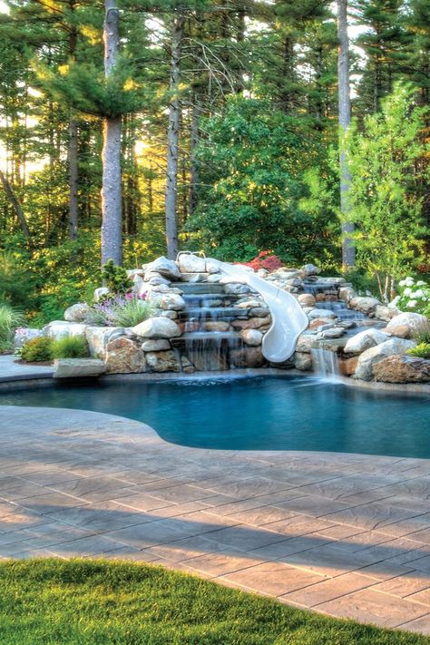 Pool Retaining Wall Ideas Sloped Yard, Backyard Pool Slide, Backyard Oasis Pool Outdoor Living, Inground Pool On A Hill Backyards, Slope Backyard Pool Ideas, Small Pool On Sloped Yard, Lagoon Pool Backyard Oasis, Rock Pools Backyard, Modern Pool With Slide