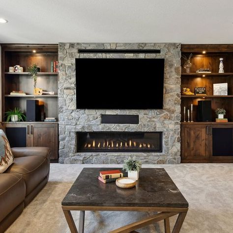 FBC Remodel | Design. Collaborate. Build Joy. on Instagram: "This Minneapolis basement is tailor-made for winter hibernation, from the warm woodwork to the cozy fireplace to the spacious bar!   #minneapolisbasementremodel #homeremodeling #basement #basementremodel #basementdesign #fbcremodel" Finished Basement Ideas With Fireplace, Fireplace Wall Basement, Fireplace In Basement Ideas, Fireplace Ideas Transitional, Basement Fireplace Ideas With Tv, Basement Fireplace With Tv, Basement Fireplace Ideas, Modern Fireplace Decor, Winter Hibernation