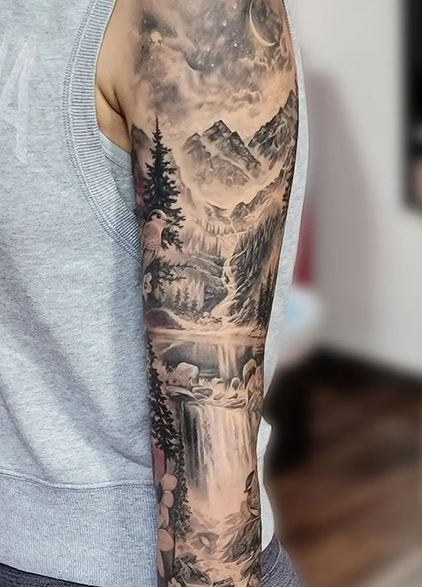 An unbelievably realistic black and grey mountain scenery sleeve tattoo, done by @katarina.heinze. Within this piece is a starry night sky with a crescent moon, trees, a waterfall, rocks, a lake, and of course the rocky peaks of the mountains. Mountain Sleeve Tattoo, Waterfall Tattoo, Natur Tattoo Arm, Scenery Tattoo, Lake Tattoo, Cream Tattoo, Sky Tattoos, Arm Sleeve Tattoos For Women, Nature Tattoo Sleeve