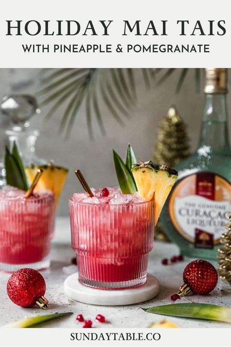 These holiday mai tais are perfect for Christmas and other winter holidays! This rum cocktail with pineapple juice, cranberry, lime, and Curacao liqueur is an easy, fun, creative, tropical drink for parties and the holidays. Use light, spiced, or dark rum depending on what you have. You can also make it in a pitcher for a crowd! Mai tais are a boozy, Hawaiian-inspired alcoholic drink but they're very drinkable and so good! If you need a Christmas drink for adults, your guests will love these. Summer Christmas Cocktails, Simple Cocktails, Hawaiian Drinks, Christmas Cocktails Easy, Pineapple Cocktail, Orange Cocktails, Christmas Drink, Pineapple Rum, Tiki Drinks