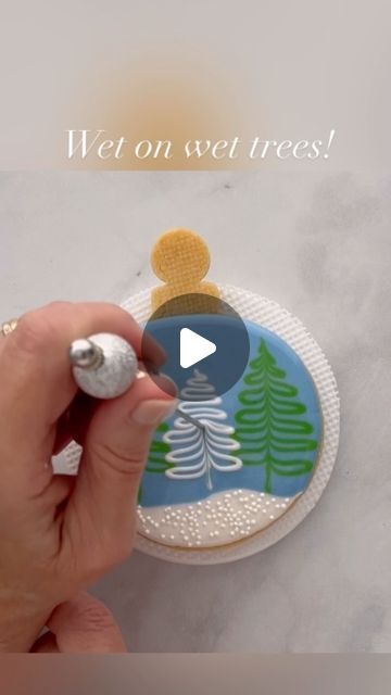 Mary Mansfield on Instagram: "I had the pleasure of creating this ornament cookie design for @annclarkcookiecutters 🌲 It’s another fun wet on wet technique, that’s quite simple to do. Visit the Ann Clark website to see more tutorials on how to decorate this shape in other ways, as well as design inspiration for other ornaments and holiday shapes!🌲❄️🌲  #cookievideo #cookiedecoratingvideo #cookiedecoratingtutorial #cookietutorial #royalicingtransfers #christmascookies #royalicing #ornamentcookies #wetonwetcookies  #royalicingcookies #decoratedcookies #icingcookies #decoratedsugarcookies  #cookiedecorating #cookiesofinstagram" Wet Royal Icing Recipe, Christmas Sugar Cookie Designs, Christmas Cookie Icing, Iced Christmas Cookies, Royal Icing Christmas Cookies, Wet On Wet Technique, Holiday Cookies Decorated, Royal Cookies, Christmas Cutout Cookies