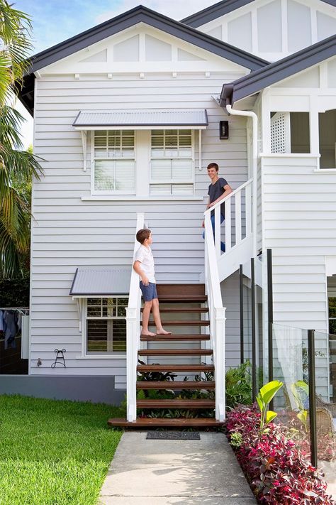 A Classic Queenslander Gets A Fresh Sense Of Purpose | Home Beautiful Magazine Australia Queenslander House Exterior, Blue Weatherboard House, Queenslander Renovation Exterior, Queenslander Exterior Colours, Modern Queenslander Exterior, Queenslander Front Stairs, Queenslander Window Awnings, White Queenslander, Grey And White Queenslander Exterior