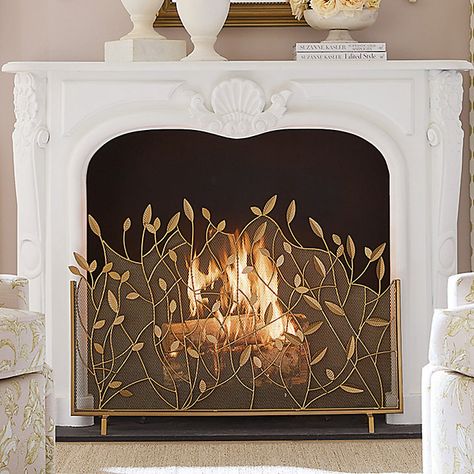 The lacy branch and leaf design was created by our own talented artist. Our Branches Fire Screen is handmade of powder-coated iron and decorated with beautifully detailed leaf details. An antique brass finish is hand applied to give this decorative fireplace guard a warm, golden glow. Branches Fire Screen features: Antique brass finish with gold accents Leaf & branch details Handmade of powder-coated iron Rust-resistant Fireplace Gate Ideas, Boho Fireplace Screen, Brass Fireplace Fender, Fireplace Makeover Rental, Brass Vent Covers, Decorating With Brass Accents, Fireplace Insert Decor, Empty Fireplace Decor, Faux Fireplace Decor