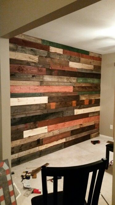 Multi colored stained pallet wall Multi Stained Wood Wall, Multi Color Wood Wall, Reclaimed Wood Accent Wall, Wall Stains, Pallet Wall Decor, Garage Pergola, Pallet Walls, Wall Planks, Focal Wall