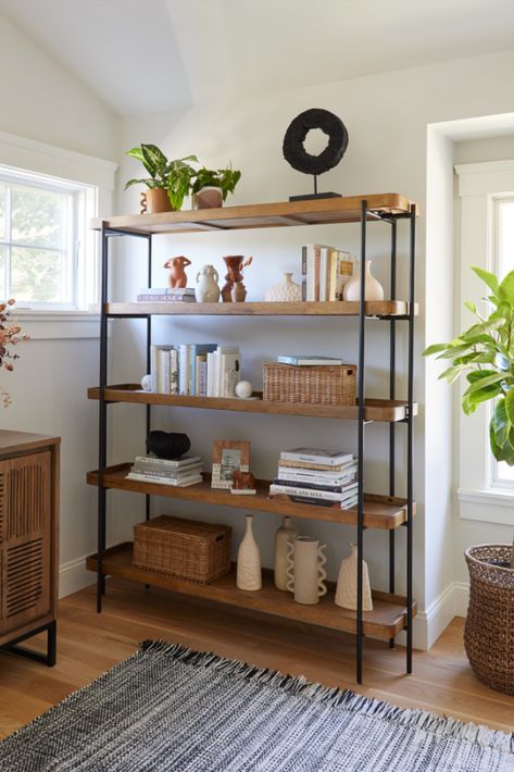 Crafted of wood with a warm vintage-acorn finish, the Kaili Bookshelf features rectangular open shelves in a sleek matte-black metal frame. Designed for versatile uses, this bookshelf is perfect for arranging with decor or plants in the living room, using as open storage in the bedroom or office and organizing serveware in the dining room or kitchen. #WorldMarket #AntonOfficeCollection #HomeOffice #HomeDecor Black Metal Bookshelf, Market Shelf, Wood Shelves Living Room, Office Furniture Decor, Unique Living Room Furniture, Wardrobe Laminate Design, Black Metal Shelf, Dining Room Shelves, Small Apartment Bedrooms