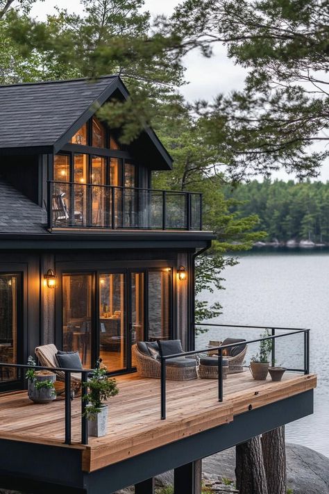 Rustic modern lake house facade with wraparound timber porch stunning Scandinavian lake view. Check out all of these charming and cozy rustic lake houses that perfectly blend with nature for the ultimate peaceful retreat. Cozy Lake House Exterior, Lake Mountain House, Building A Lake House, Chalet Lake House, Exterior Lake House Ideas, Lake House Decks And Patios, Big House Design Exterior, Lake House Screened In Porch, Minimalist Lake House