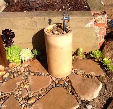 Backyard Drinking fountain - no more kids running into the house for a drink - upcycled chimney flue section, broken concrete and cobble. Raised Garden Bed Along Fence, Garden Bed Along Fence, Outdoor Drinking Fountain, Drinking Water Fountain, Home Fountain, Diy Garden Fountains, Fountains Backyard, Diy Fountain, Drinking Fountains