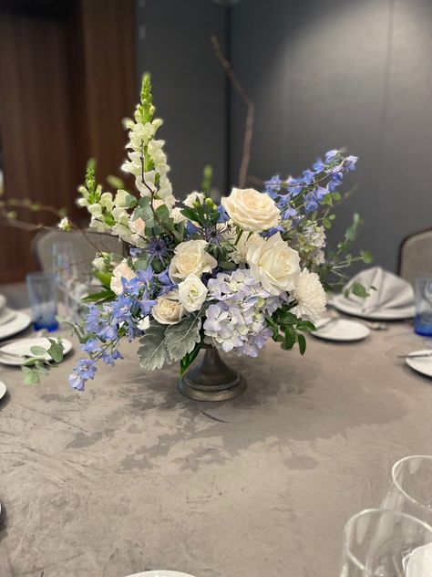 Wedding centerpiece inspiration with elegant hints of blue/purple throughout! Centerpieces Wedding Blue And White, Blue And Green Centerpieces Wedding, Coastal Centerpiece Ideas Wedding, Purple Floral Centerpieces, Blue And White Flower Centerpieces, Blue Green Flower Arrangements, Blue Centerpieces Wedding, Blue Delphinium Centerpiece, Hydrangea And Delphinium Centerpiece