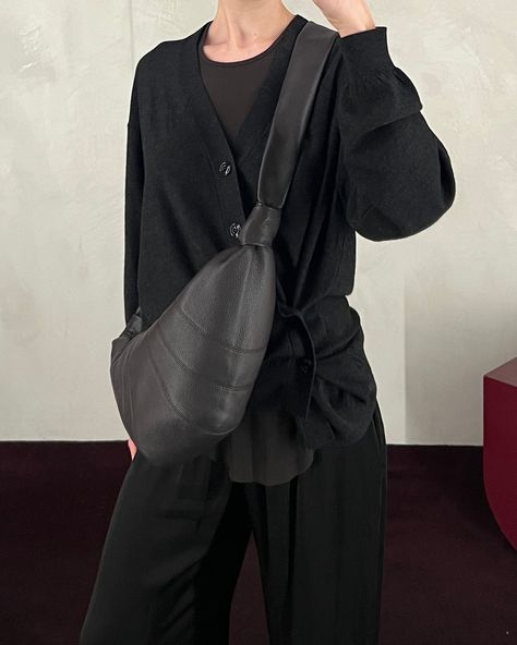 The anthracite twisted cardigan and dark chocolate medium croissant bag by Lemaire styled with Rick Owens' dark dust rib tank, Jaga black meloni pants and Guidi black 992 classic derby.⁠ ⁠ New arrivals are available in-store now and online soon. Lemaire Croissant Bag, Croissant Bag, Visual Design, Rick Owens, Dark Chocolate, Derby, New Arrivals, In Store, Twist