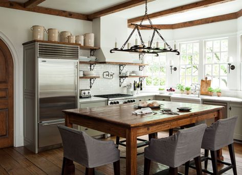 Not All Kitchens Have Islands — The Resurgence of the Center Table. Barbara Westbrook. Classic kitchen with taupe cabinets, marble counters, and rustic beams. Casa Cook, Kitchen Island With Seating, Farmhouse Kitchen Design, Island With Seating, Grey Kitchens, Farmhouse Style Kitchen, Trendy Kitchen, Wood Kitchen, Dream Kitchen