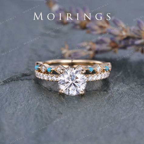 Vintage Moissanite Engagement Ring Set Yellow Gold 7.5mm Moissanite Ring Unique Diamond Turquoise Wedding Band Bridal Solitaire Ring 2pcs ENGAGEMENT RING: ♥ Ring Mounting: 14K Rose Gold ♥ Bandwidth about 1.6mm ♥ Main Stone: Moissanite, D-E-F Clarity Size: 7.5mm, Round Cut. ♥ Accent Stones: natural diamond or colorless moissanite, about 0.28ct Wedding Band: ♥ Ring Mounting: Solid 14K Rose Gold ♥ Band Width: about 1.6mm (back, plain gold part) ♥ Accent Stones: Natural Diamonds or Colorless Moissan Wedding Rings With Turquoise Accent, Wedding Rings Engagement Western, Western Inspired Wedding Rings, Silver And Turquoise Engagement Ring, Diamond Engagement Ring With Turquoise Band, Wedding Ring Country, Gold Turquoise Wedding Ring, Vintage Yellow Gold Turquoise Wedding Ring, Turquoise Wedding Ring With Accent Stones