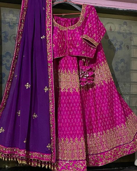 This is a pink lehenga with a purple dupatta to contrast it. Both have gold handwork designs. This vibrant coloured lehenga is perfect for an evening event/wedding/sangeet. Purple And Pink Lehenga, Combination For Purple Color, Contrast With Pink Colour Suit, Magenta Lehenga Color Combos, Contrast Colour For Pink, Colour Combinations Lehenga, Dupatta Designs Ideas Color Combinations, Lehenga Colour Combination, Lehnga Designs Color Combinations