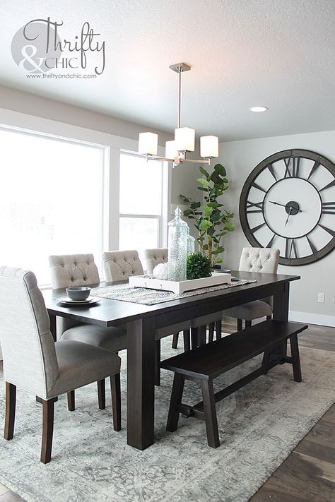 Dining room decorating idea and model home tour Grey Upholstered Dining Chairs, Dining Room Decorating, Big Clocks, Modern Farmhouse Dining Room, Dining Room Table Centerpieces, Dining Table Accessories, Family Dining Rooms, Modern Farmhouse Dining, Dining Room Table Decor