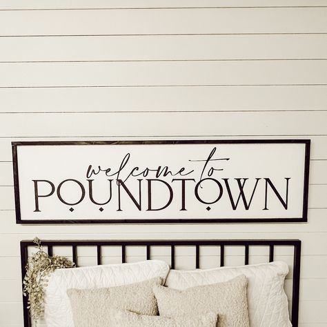 "welcome to poundtown  Free shipping in the continental U.S. White background with black lettering and your choice of frame color.  (to change the background or lettering color, put a note in the comment section at checkout) The 3D elements offer a bolder dimensional look and are made from 1/4\" laser cut boards, and are securely attached to the sign. The standard (not 3D) option offers a softer feel with all lettering painted. Available in 6 sizes: Shelf size - 7.5\" x 25.5\" x 1.5\" Twin size - 10.5\" x 37.5\" x 1.5\" Queen size - 13.5\" x 49.5\" x 1.5\" Queen Large -17.5\" x 49.5\" x 1.5\" King size - 13.5\" x 66\" x 1.5\" King Large - 17.5\" x 61.5\" x 1.5\" (give or take half an inch on all dimensions) Each sign has two claw hooks for easy hanging.  I will do my absolute best to get y Bed Signs Wall Art, Sign Over Bed Master Bedrooms, Above The Bed Decor Master, Diy Over The Bed Wall Decor Ideas Master Bedrooms, Over The Bed Sign, Welcome To Poundtown Sign, Wall Decor Bedroom Above Bed Master Suite, Poundtown Sign, Over The Bed Wall Decor For Couples